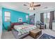 Spacious main bedroom featuring a ceiling fan, comfy chair, and turquoise walls at 900 W Broadway Ave # 66, Apache Junction, AZ 85120