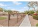 Paved walking path winds through a serene community space, surrounded by trees and landscaping at 900 W Broadway Ave # 66, Apache Junction, AZ 85120