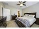 Comfortable bedroom with dark wood furnishings and ensuite bathroom access at 9149 E Auburn St, Mesa, AZ 85207