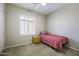 Cozy bedroom with a shuttered window and a simple, clean design at 9149 E Auburn St, Mesa, AZ 85207