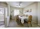 Inviting dining room with seating for six, a ceiling fan, and plantation shutters at 9149 E Auburn St, Mesa, AZ 85207