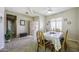 Dining room featuring tile floors, a wooden dining set, and bright shuttered windows at 9149 E Auburn St, Mesa, AZ 85207