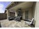 Covered patio featuring stone flooring, outdoor seating, ceiling fan, and yard access at 9149 E Auburn St, Mesa, AZ 85207