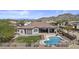 Stunning aerial view of a backyard featuring a pool, patio furniture, and serene mountain views in the background at 9161 W Bajada Rd, Peoria, AZ 85383