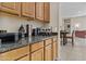 Wet bar with granite counters, wooden cabinetry, and adjacent dining area at 9161 W Bajada Rd, Peoria, AZ 85383