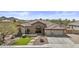 Charming home with a stone facade, arched entryway, three-car garage and desert landscaping at 9161 W Bajada Rd, Peoria, AZ 85383