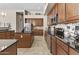 Spacious kitchen with stainless steel appliances, center island, tile floors, and backsplash at 9161 W Bajada Rd, Peoria, AZ 85383