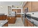 Spacious kitchen featuring stainless steel appliances, a center island, and ample wood cabinetry at 9161 W Bajada Rd, Peoria, AZ 85383