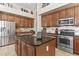 A kitchen with stainless steel appliances, a center island, tile floors, and overhead lighting at 9161 W Bajada Rd, Peoria, AZ 85383