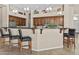 A kitchen with stainless steel appliances, a breakfast bar with stools, and pendant lighting at 9161 W Bajada Rd, Peoria, AZ 85383