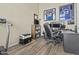 Well-lit home office featuring wood-look floors and multiple work stations at 9161 W Bajada Rd, Peoria, AZ 85383