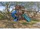 Fun wooden playhouse with slide and swing set in a grassy backyard at 9161 W Bajada Rd, Peoria, AZ 85383