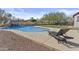 Relaxing poolside view with a chaise lounge, a waterfall feature, and lush landscaping for a tranquil escape at 9161 W Bajada Rd, Peoria, AZ 85383