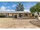 Spacious backyard view with covered patio featuring a convenient window bar at 9614 W Pleasant Valley Rd, Sun City, AZ 85351