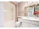 Bright bathroom featuring a white vanity, framed mirror and shower-tub combination with white tiling at 9614 W Pleasant Valley Rd, Sun City, AZ 85351