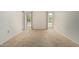 Empty bedroom featuring carpeting, white walls, and two bright windows offering views of the outdoors at 9614 W Pleasant Valley Rd, Sun City, AZ 85351