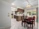 Dining area features a chandelier and sliding doors to outside and open to kitchen at 9614 W Pleasant Valley Rd, Sun City, AZ 85351