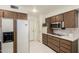 Functional kitchen with stainless steel microwave, cooktop, and white appliances at 9614 W Pleasant Valley Rd, Sun City, AZ 85351