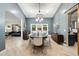 The dining room offers access to the backyard through sliding doors and is accented by a sliding barn door at 10055 E Charter Oak Rd, Scottsdale, AZ 85260