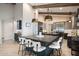 Stylish kitchen with an oversized island, seating for four, and modern lighting fixtures at 10055 E Charter Oak Rd, Scottsdale, AZ 85260