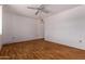 Spacious bedroom with a ceiling fan, a large window, and wood-look flooring at 10201 W Cinnebar Ave, Sun City, AZ 85351