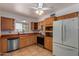 Bright kitchen featuring wooden cabinets, stainless steel appliances, and a view from the window at 10201 W Cinnebar Ave, Sun City, AZ 85351