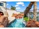 Backyard area with custom designed stone water feature and outdoor fireplace at 10365 N 101St Pl, Scottsdale, AZ 85258