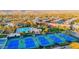 Aerial view of the community tennis courts and pool, with a neighborhood of single Gathering homes in the distance at 11416 E Palomino Rd, Scottsdale, AZ 85259