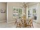 Dining room boasts a modern light fixture, large windows and access to outdoor living at 11416 E Palomino Rd, Scottsdale, AZ 85259