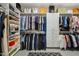 Organized walk-in closet with ample shelving, hanging space, and designer accessories for a stylish wardrobe at 11416 E Palomino Rd, Scottsdale, AZ 85259