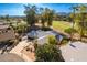 Beautiful aerial view of the home, landscaping, and surrounding golf course and pond at 11612 S 51St St, Phoenix, AZ 85044