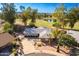 Aerial view of a single-story home near a golf course and pond showcasing the front yard at 11612 S 51St St, Phoenix, AZ 85044