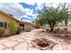 Spacious backyard featuring a charming fire pit area, perfect for relaxing and entertaining guests at 11612 S 51St St, Phoenix, AZ 85044