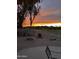 Backyard features a fire pit and view of the golf course at sunset at 11612 S 51St St, Phoenix, AZ 85044