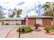 Charming single-story home with an American flag, desert landscaping, and a curved driveway at 11612 S 51St St, Phoenix, AZ 85044