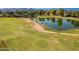 View of lush golf course with pond surrounded by trees and blue skies at 11612 S 51St St, Phoenix, AZ 85044