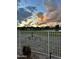 View of the golf course at sunset framed by an ornate fence at 11612 S 51St St, Phoenix, AZ 85044