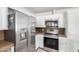Kitchen featuring stainless steel appliances and granite countertops with white cabinets at 11612 S 51St St, Phoenix, AZ 85044