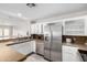 Bright kitchen with stainless steel appliances, granite countertops, and white cabinets at 11612 S 51St St, Phoenix, AZ 85044