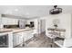 Well-lit kitchen with an island featuring bar stool seating and stainless steel appliances at 11612 S 51St St, Phoenix, AZ 85044