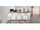 Modern kitchen with an island featuring bar stool seating and tile flooring at 11612 S 51St St, Phoenix, AZ 85044
