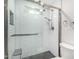 Modern bathroom shower featuring subway tile, glass enclosure, shower bench and gray tile floor at 11612 S 51St St, Phoenix, AZ 85044