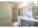 Tidy bathroom featuring a glass shower, tiled floors, and a stylish vanity at 11666 N 28Th Dr # 196, Phoenix, AZ 85029