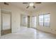 Bedroom with mirrored closet, a window, and light wood-look floors at 11666 N 28Th Dr # 196, Phoenix, AZ 85029