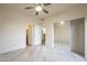 Bedroom featuring light wood-look floors, ceiling fan, and mirrored closet at 11666 N 28Th Dr # 196, Phoenix, AZ 85029
