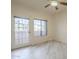 Bedroom with light wood-look floors, a ceiling fan, a window, and an exit door at 11666 N 28Th Dr # 196, Phoenix, AZ 85029