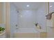 The bright white bathroom features a tiled shower and tub combo at 13229 W Marble Dr, Sun City West, AZ 85375