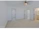 This bedroom features neutral colors with a ceiling fan and view into the closet at 13229 W Marble Dr, Sun City West, AZ 85375