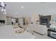 Kitchen island with seating opens into a living room with fireplace and dining area at 13229 W Marble Dr, Sun City West, AZ 85375