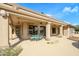 Covered back patio with dining set and scenic views of the desert landscape at 15751 W Linksview Dr, Surprise, AZ 85374